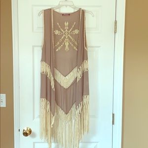 Sleeveless fringe and crochet cover up.